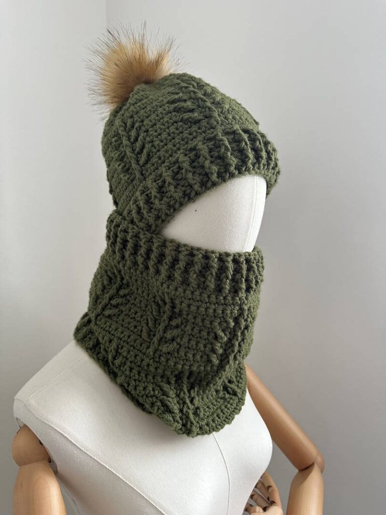 Evergreen Christmas crochet hat and cowl set worn on mannequin, winter textured crochet accessories