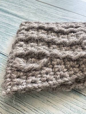 Close-up of a cable weave crochet headband highlighting the textured cable and aran stitch detail small size