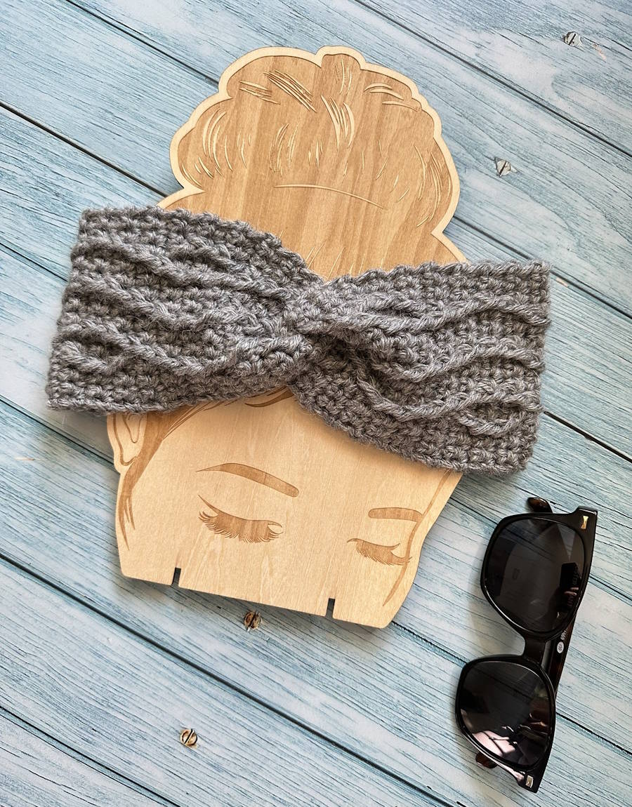 twisted cable weave crochet headband styled with accessories as a modern winter ear warmer