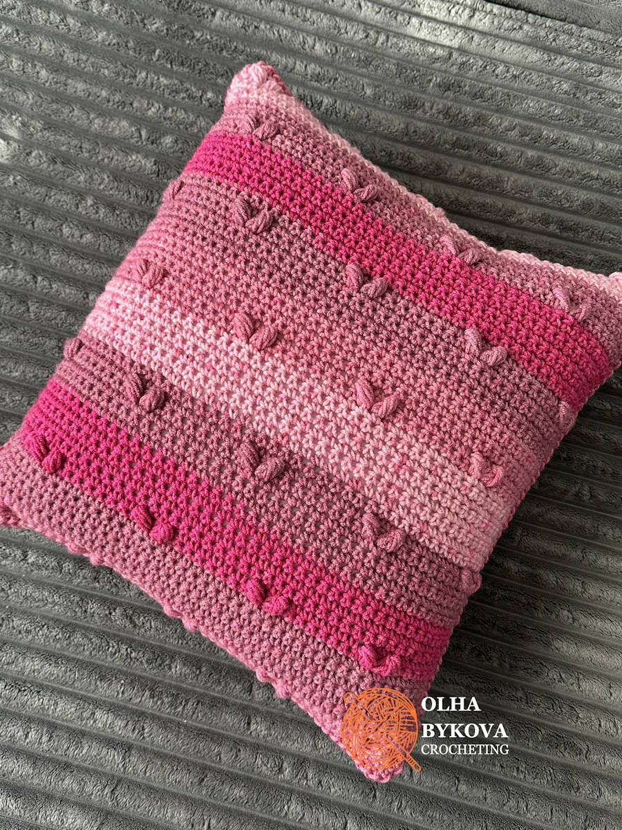 Finished textured crochet pillow case with heart stitches, perfect for Valentine’s Day home decor.