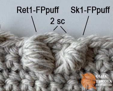 Close-up of textured heart crochet stitch made with front post puff stitches in a free crochet pillow pattern.