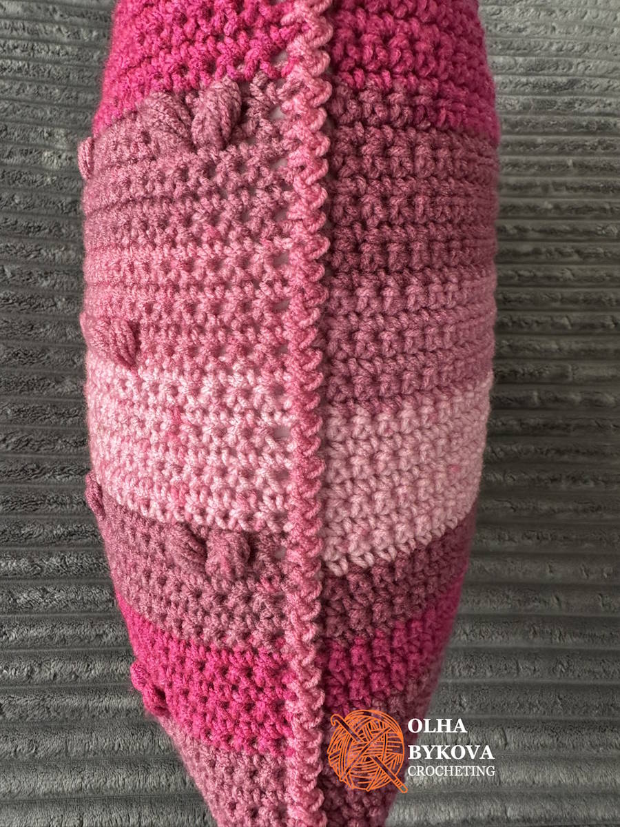 Side view of zigzag slip stitch seam on a finished textured crochet pillow cover.