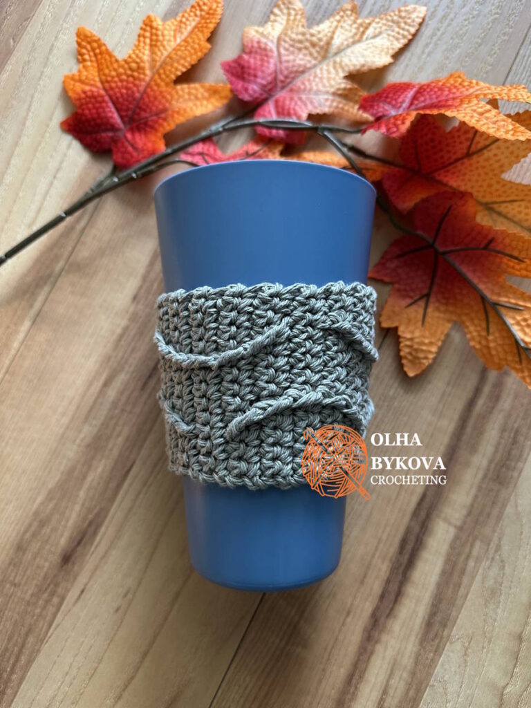 Crochet cup cozy on reusable cup, textured ripples coffee sleeve pattern free, soft aran style stitches