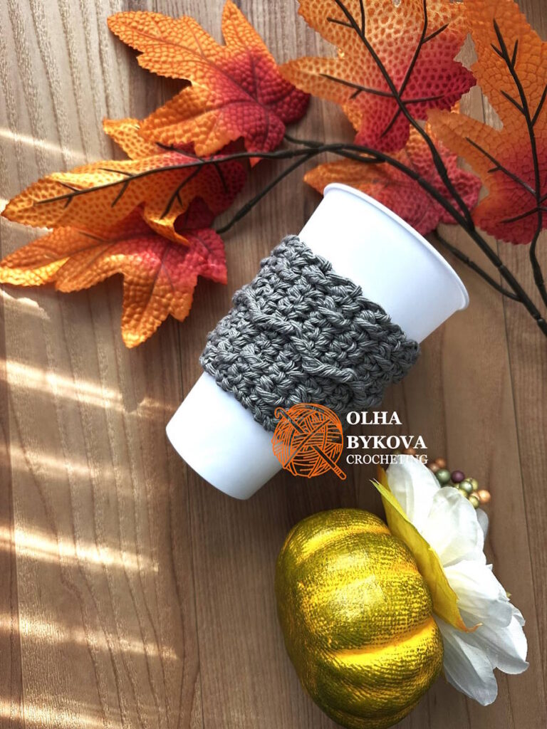 Crochet coffee sleeve on cup, Mountain Trail cup cozy pattern with textured aran stitches, cozy fall handmade accessory.