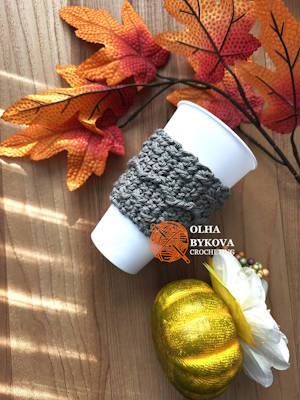Crochet coffee sleeve on cup, Mountain Trail cup cozy pattern with textured aran stitches, cozy fall handmade accessory Preview