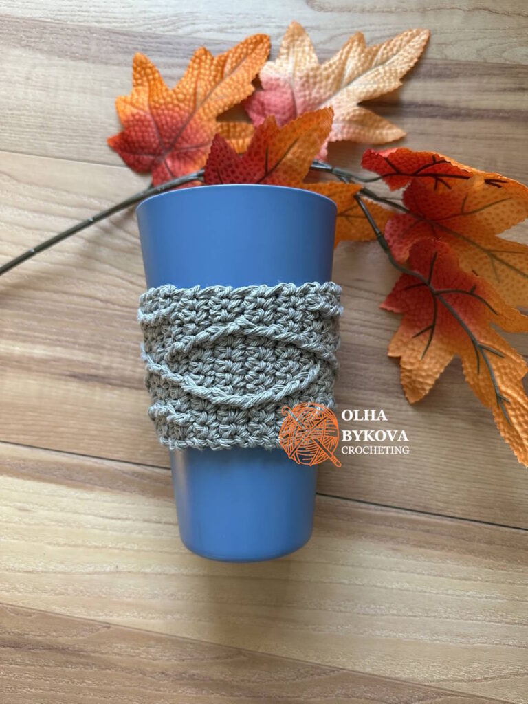 Crochet cup cozy on reusable cup, Diamond Weave textured coffee sleeve free pattern with aran and cable inspired stitches