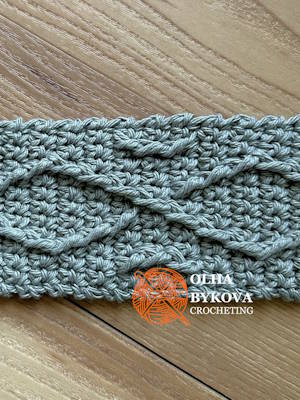 Close-up of textured crochet diamond weave stitches, cup cozy pattern with cable-inspired aran texture. Preview