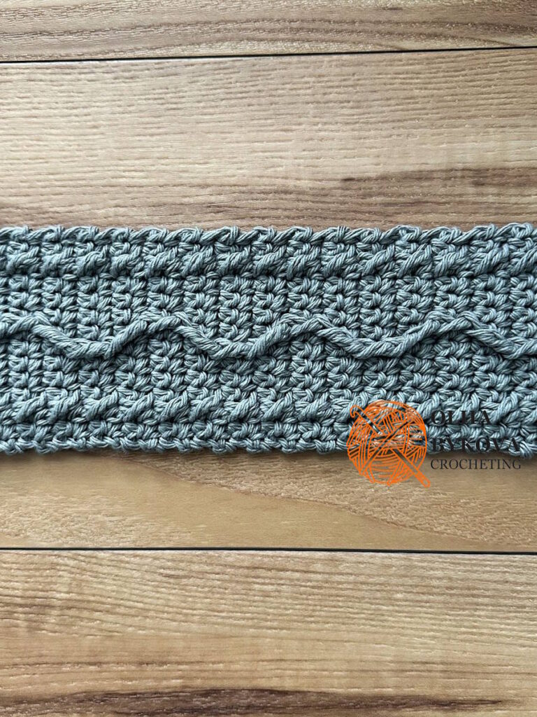 Close-up of textured crochet stitches, cable and aran inspired Wavy Line pattern for cup cozy