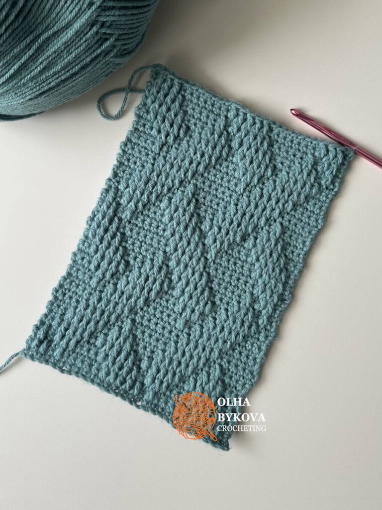 Shadow basketweave crochet stitch textured swatch with yarn and hook, free crochet stitch pattern showing woven texture