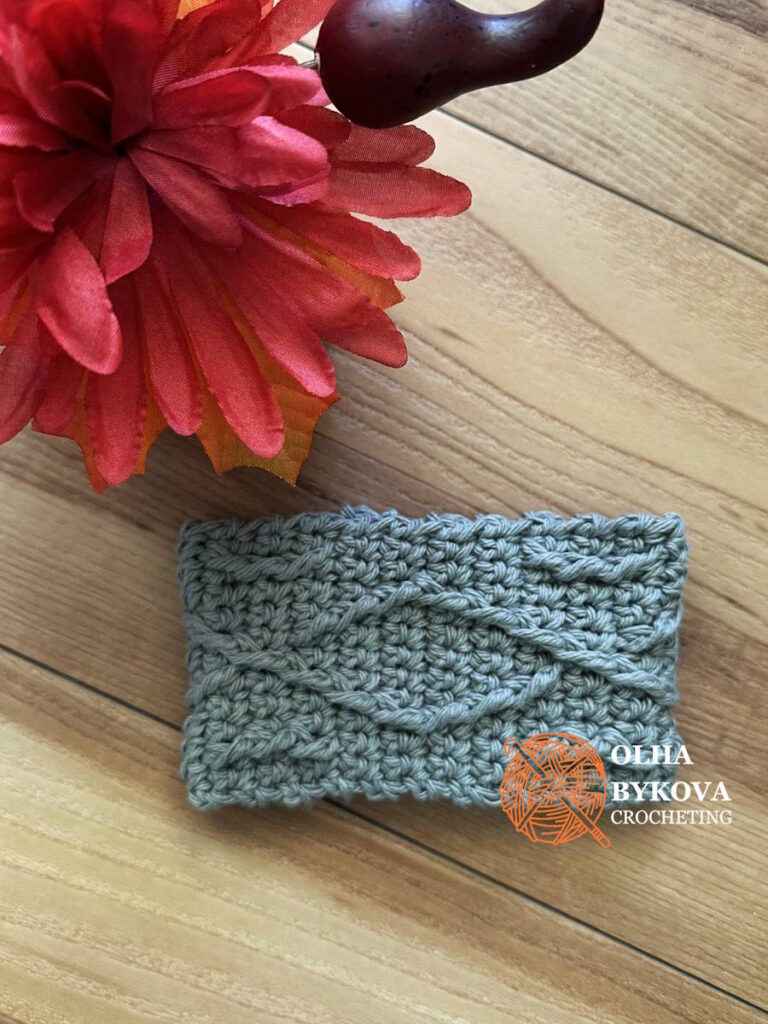 Textured crochet cup cozy Diamond Weave pattern, coffee sleeve design with woven stitch texture on wooden background