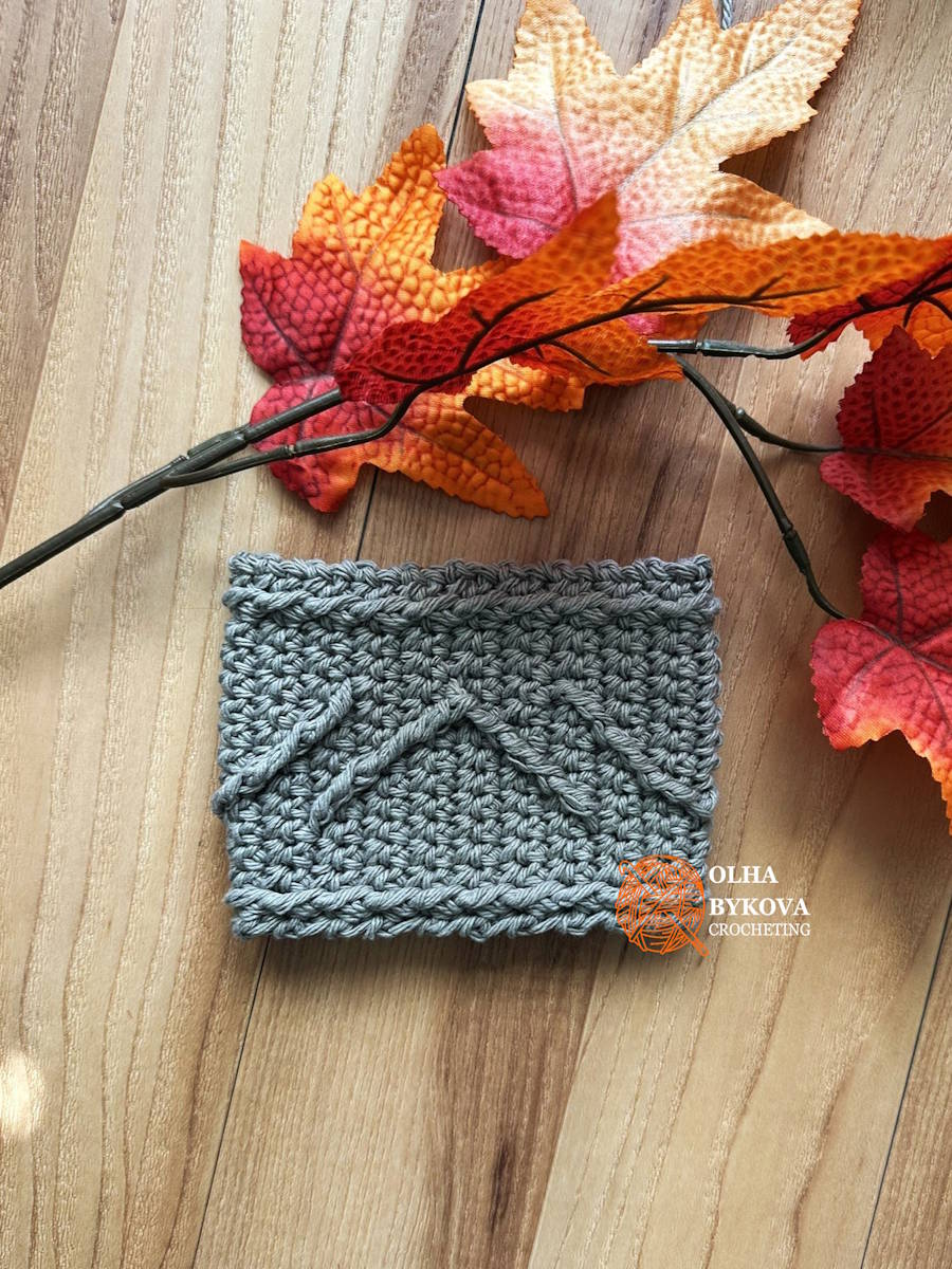 Flat lay crochet cup cozy showing chevron ridge textured pattern, easy crochet coffee sleeve design