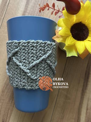 crochet cup cozy with textured cable pattern on reusable coffee cup slider preview