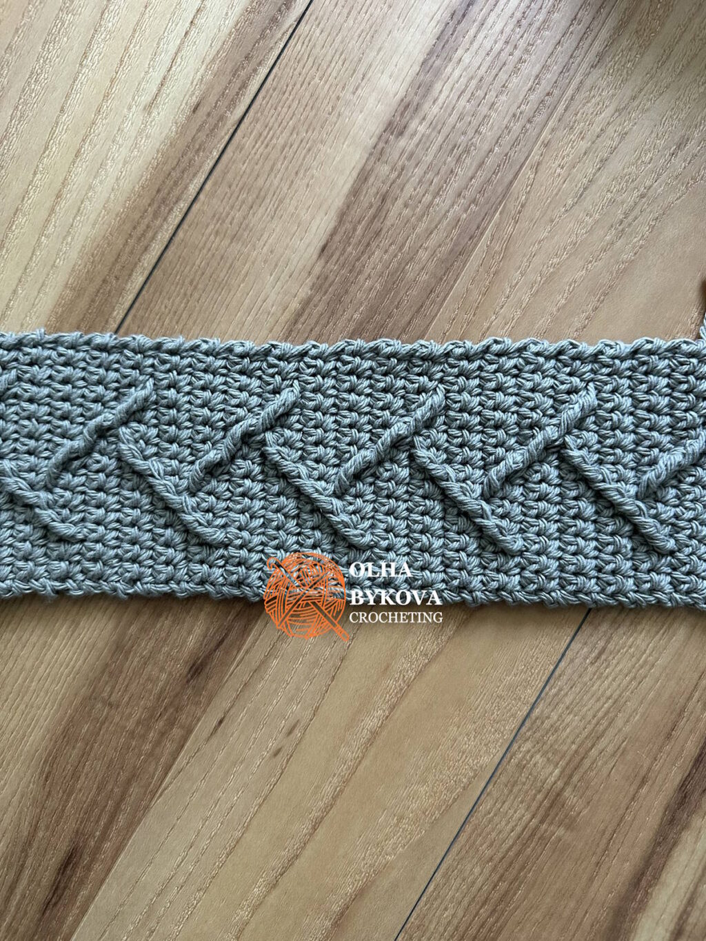 textured crochet swatch of mountain peaks cup cozy with cable and aran style stitches