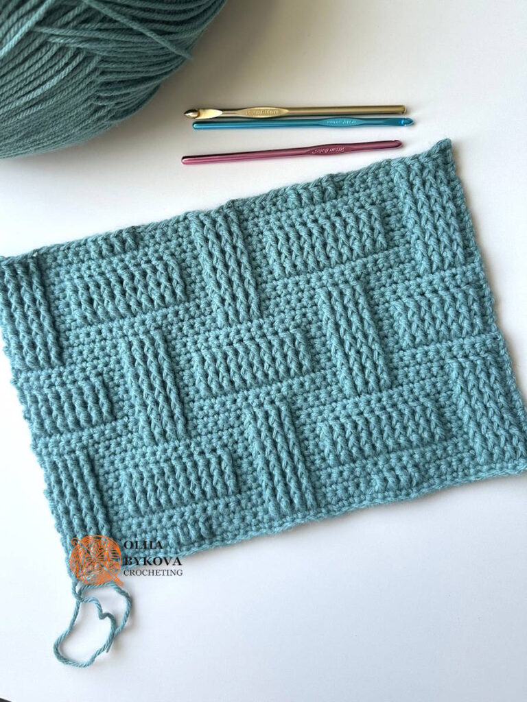 Basketweave crochet stitch pattern swatch with textured brick design and crochet hooks, perfect for blankets and modern crochet projects