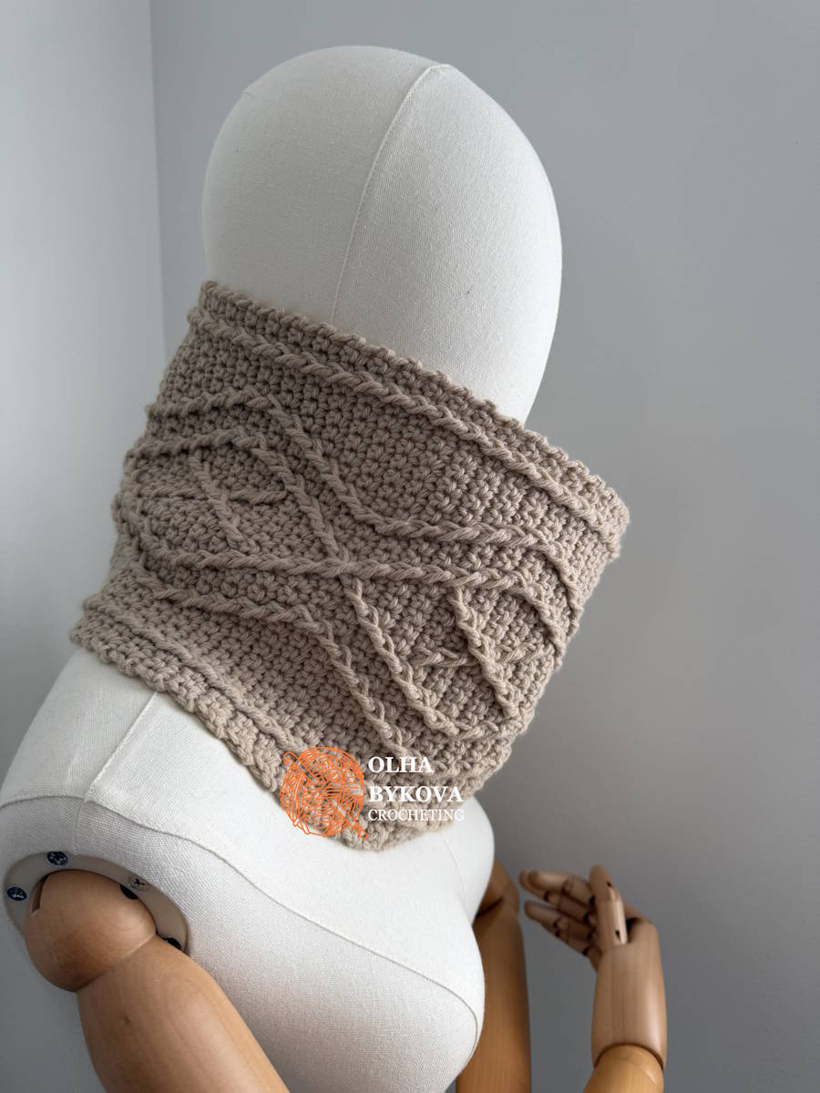 Diamond Frame crochet cowl worn around the neck, showing its raised cable texture and comfortable fit.