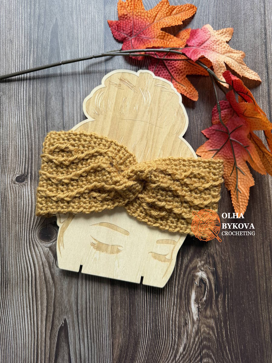 Textured crochet ear warmer pattern finished with a twist front in golden yellow yarn