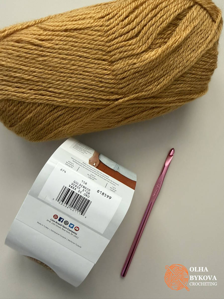 Lion Brand Touch of Alpaca yarn for a textured crochet ear warmer in Goldenrod