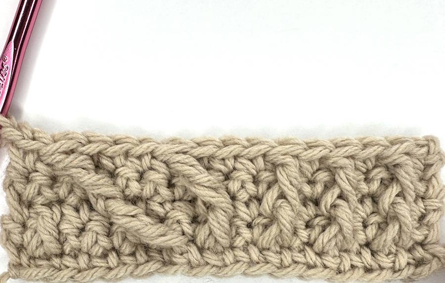 Row 5 showing how to crochet a headband with raised post stitches developing into a textured crochet ear warmer pattern